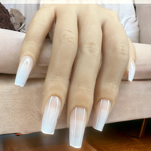 Fingers wearing long white Ombre coffin shape press-on nails.